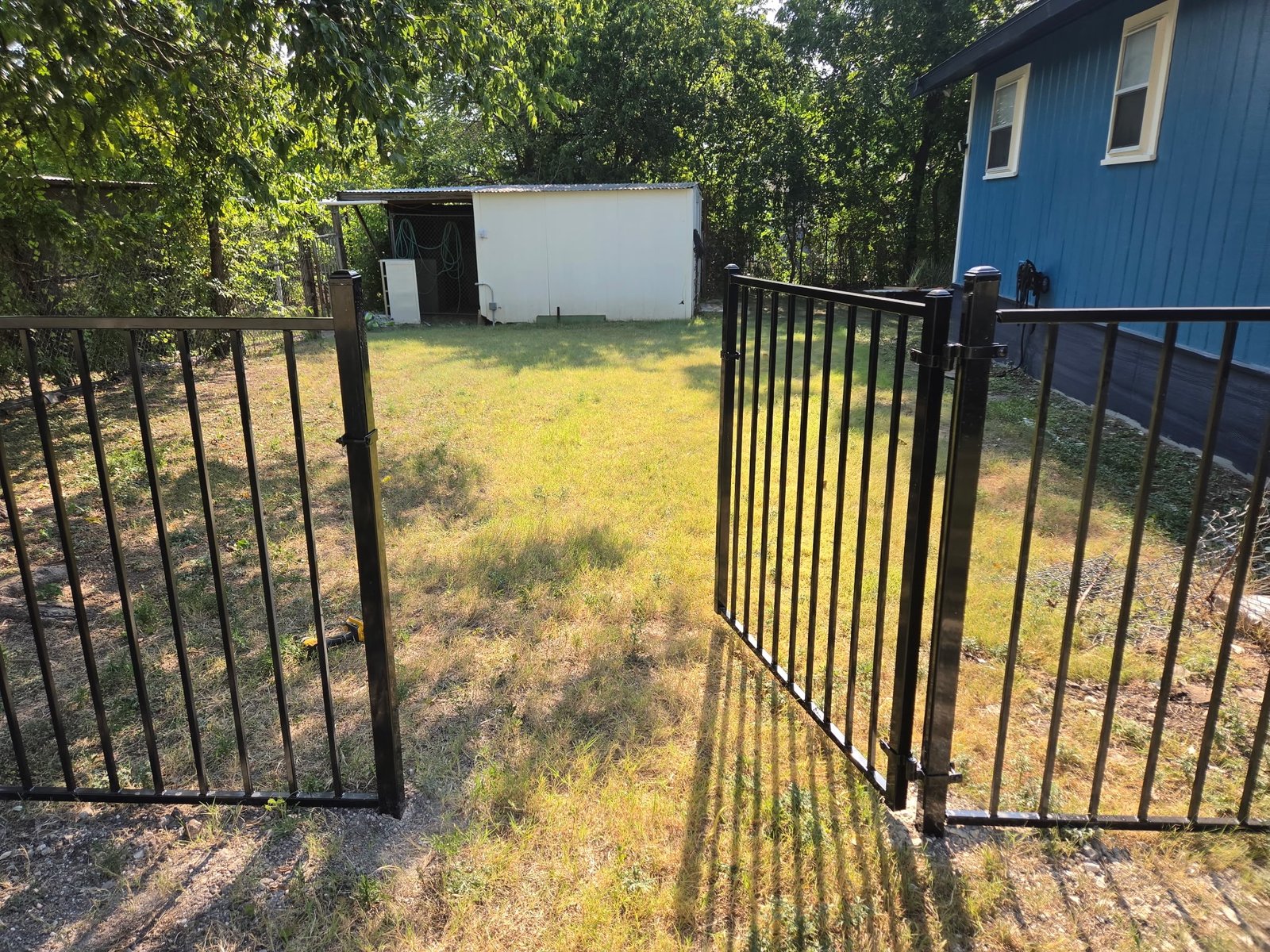 Black metal yard fence and gate